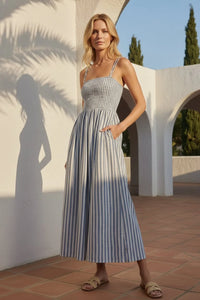 Nadine striped maxi dress: woman in sleeveless blue white vertical stripe maxi