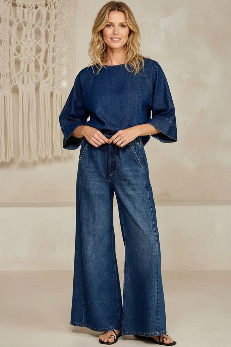 Woman in drawstring wide leg denim: navy blue top with bell sleeves