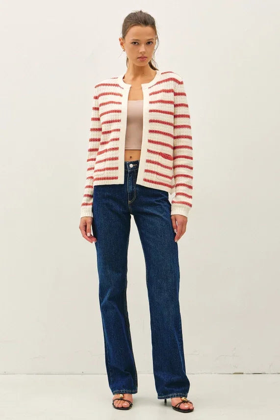 Woman in chunky knit striped open cardigan with red and white stripes