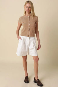 A woman wears a tahni striped button-front top in tan and beige paired with white pleated shorts