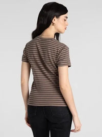 A woman wearing a slim fitting thread and supply annie tee basic top with brown and black horizontal stripes