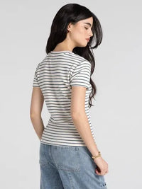 A woman wears a slim fitting thread and supply annie tee basic top with short sleeves and black and white stripes