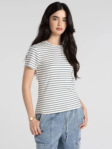 A woman wears a slim fitting basic top thread and supply annie tee with thin black and white horizontal stripes