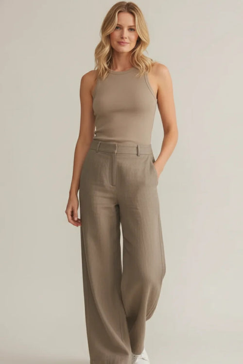 Woman in Hadley Basic Tank: taupe sleeveless top with wide-leg trousers