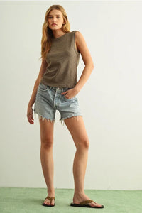 Woman in sleeveless cotton round neck top, olive green relaxed fit