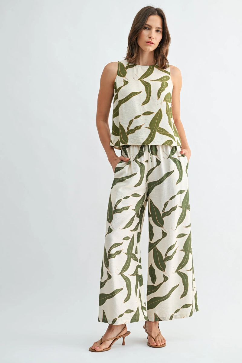 Woman in leaf print elastic waist wide leg pants, off-white green pattern
