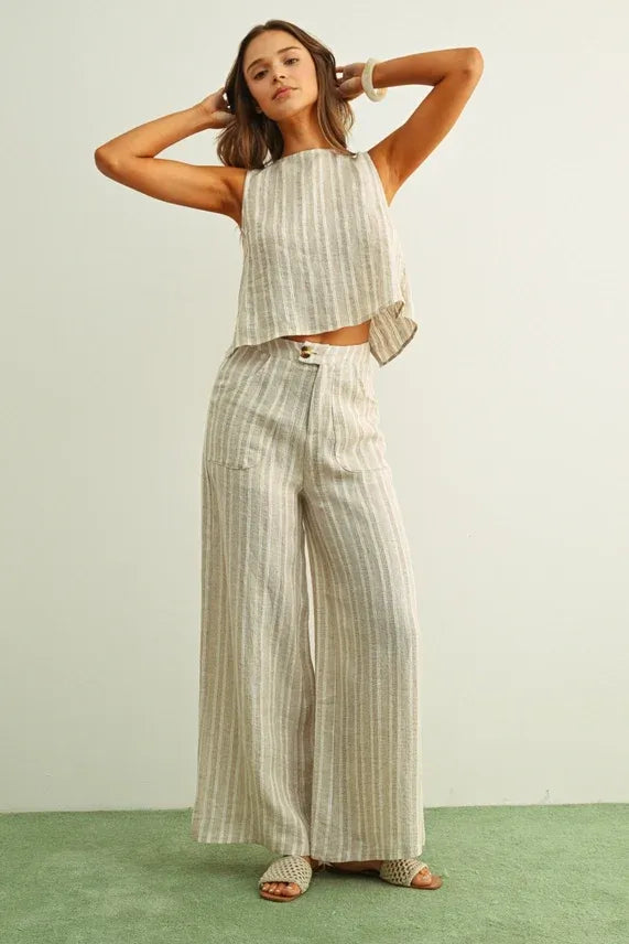A woman wearing beige and light gray jacquard linen pockets pants in a matching two-piece women’s boho chic outfit