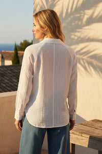 Woman in perfect airy button down shirt, white textured long-sleeve