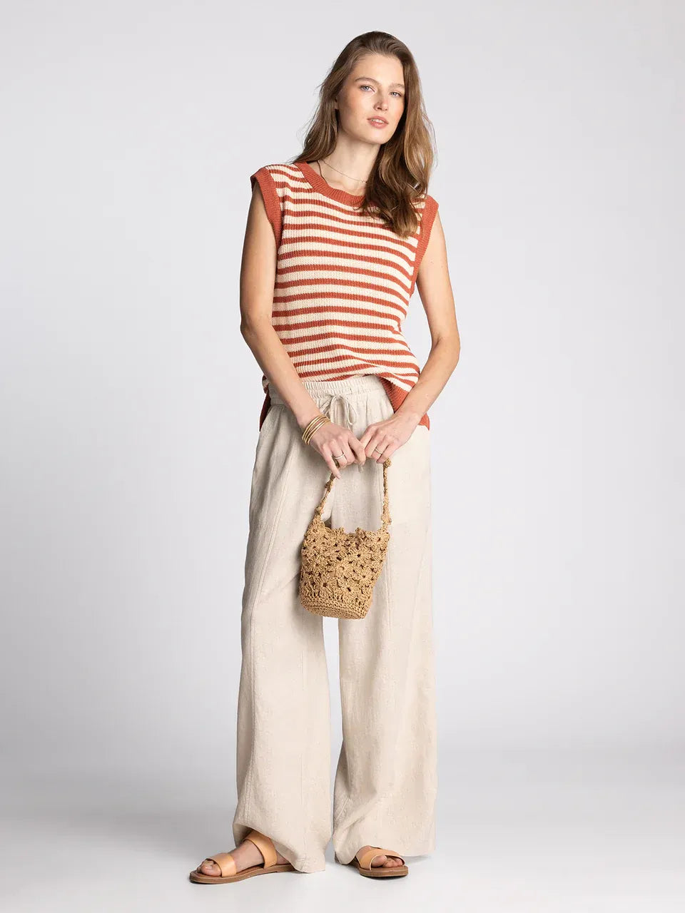A woven straw bucket bag in natural tan with handcrafted texture by supply orta for women’s boho chic clothing shop daisy