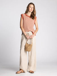 A woven straw bucket bag in natural tan with handcrafted texture by supply orta for women’s boho chic clothing shop daisy