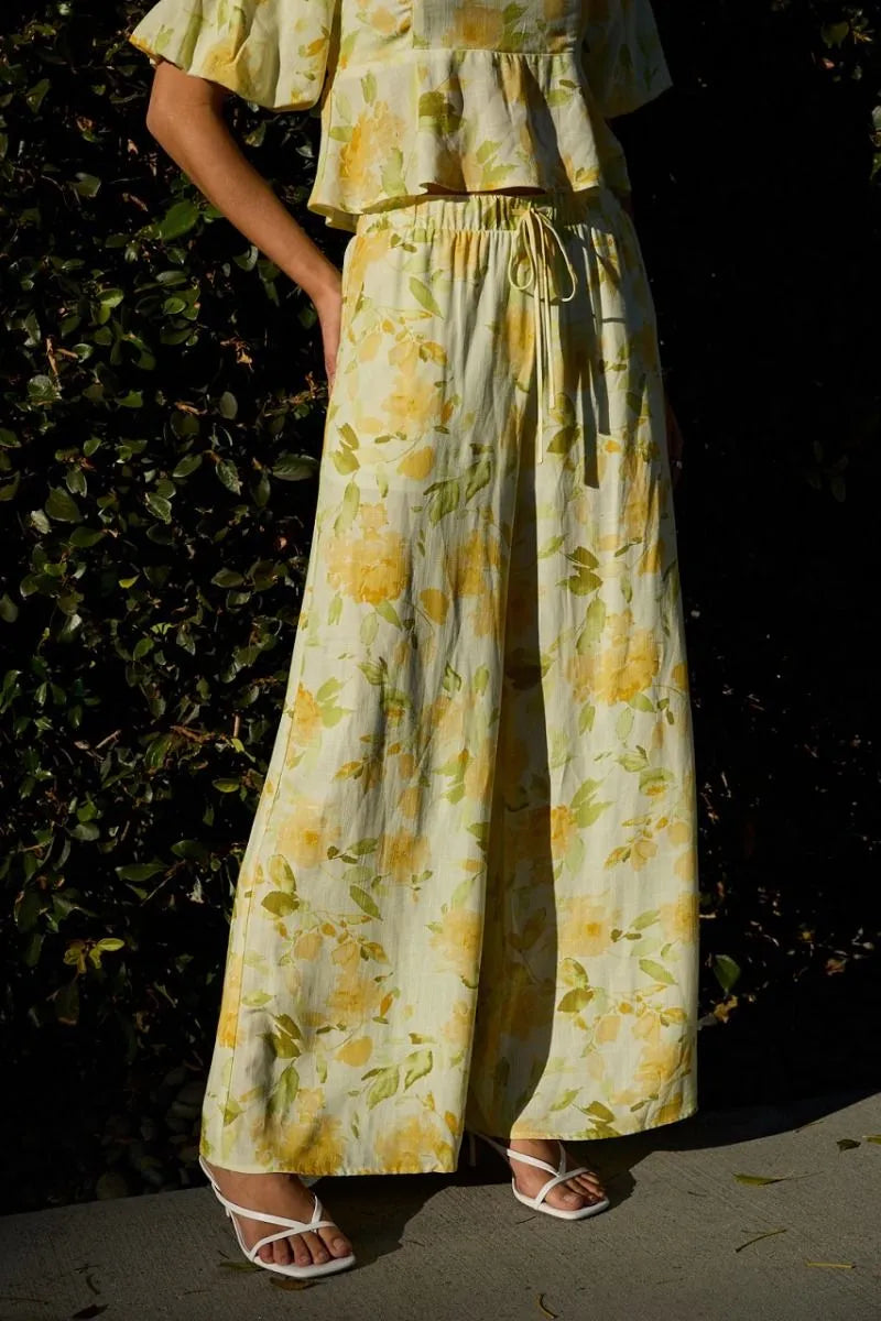 Yellow floral midi rise elastic wide-leg pants with matching top featuring elastic waist band and flowing fabric