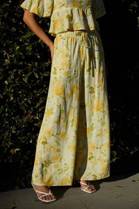 Yellow floral midi rise elastic wide-leg pants with matching top featuring elastic waist band and flowing fabric