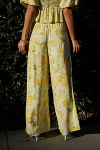 Yellow floral wide-leg midi rise elastic pants with soft flowing fabric and comfortable elastic waist band