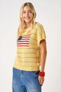 Yellow knitted sweater top with red white and blue american flag patch design on the front