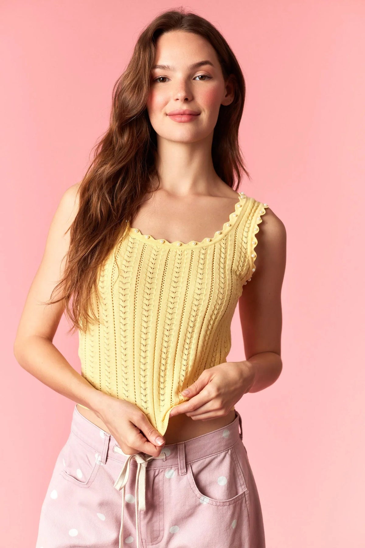 Yellow ribbed knit sleeveless top with scalloped neckline featuring pearl studs knit detailing and studs knit tank design