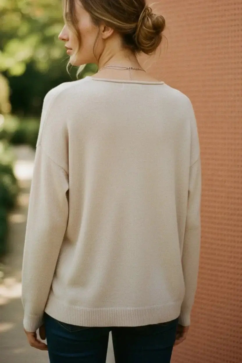 Cream-colored soft-knit sweater with cursive love and relaxed fit for perfect Valentines Day