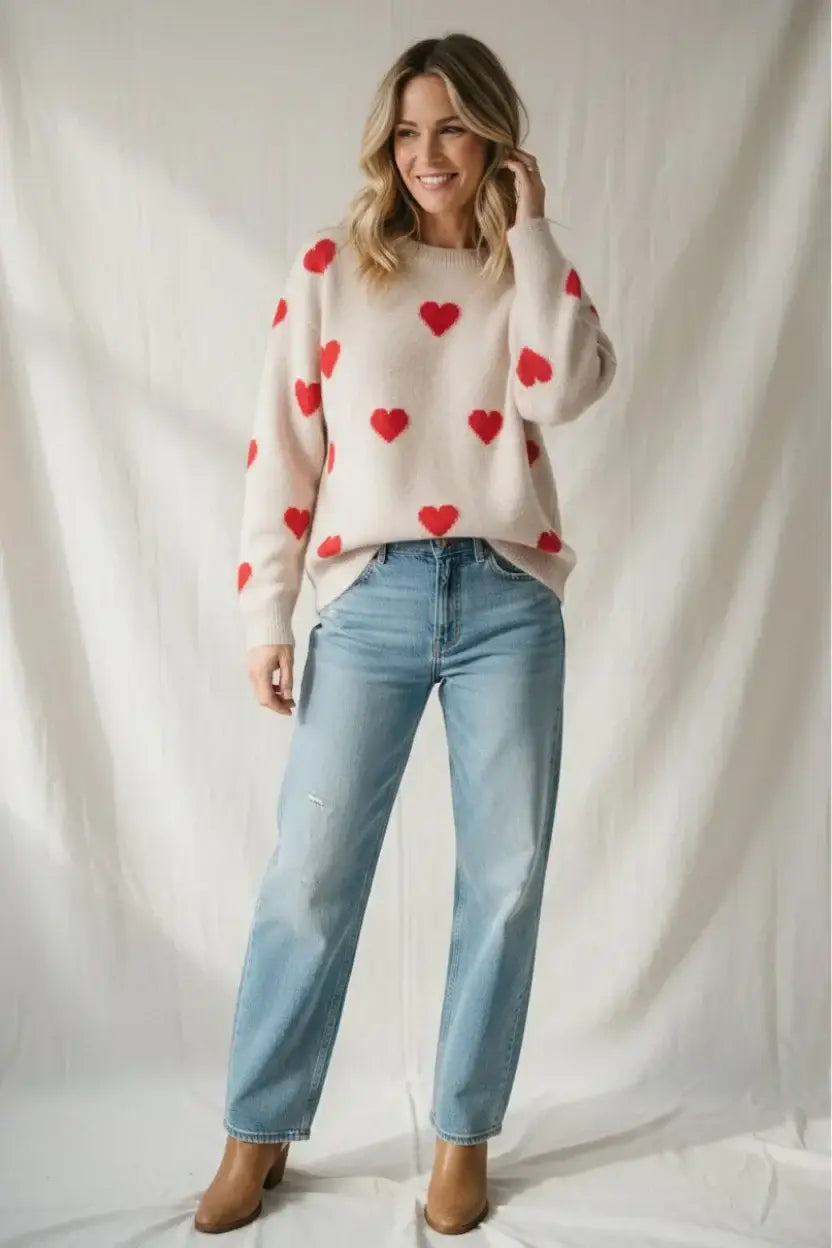 Cream-colored knit sweater with red heart pattern for Valentine’s Day