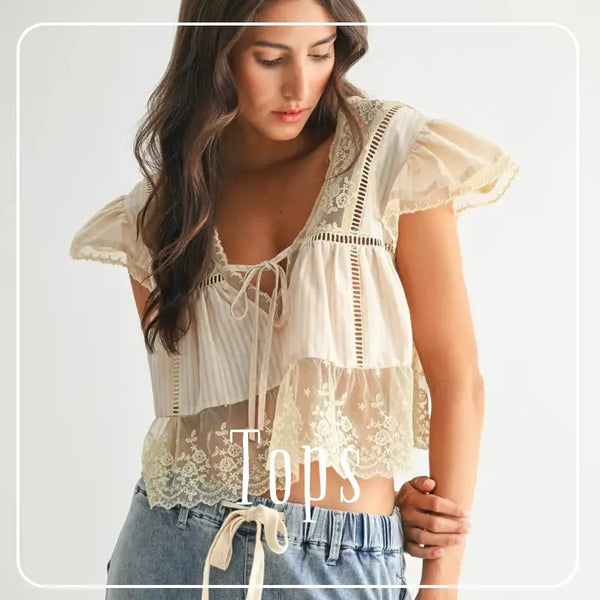 A delicate cream-colored lace top with ruffled sleeves and a tie-front design.