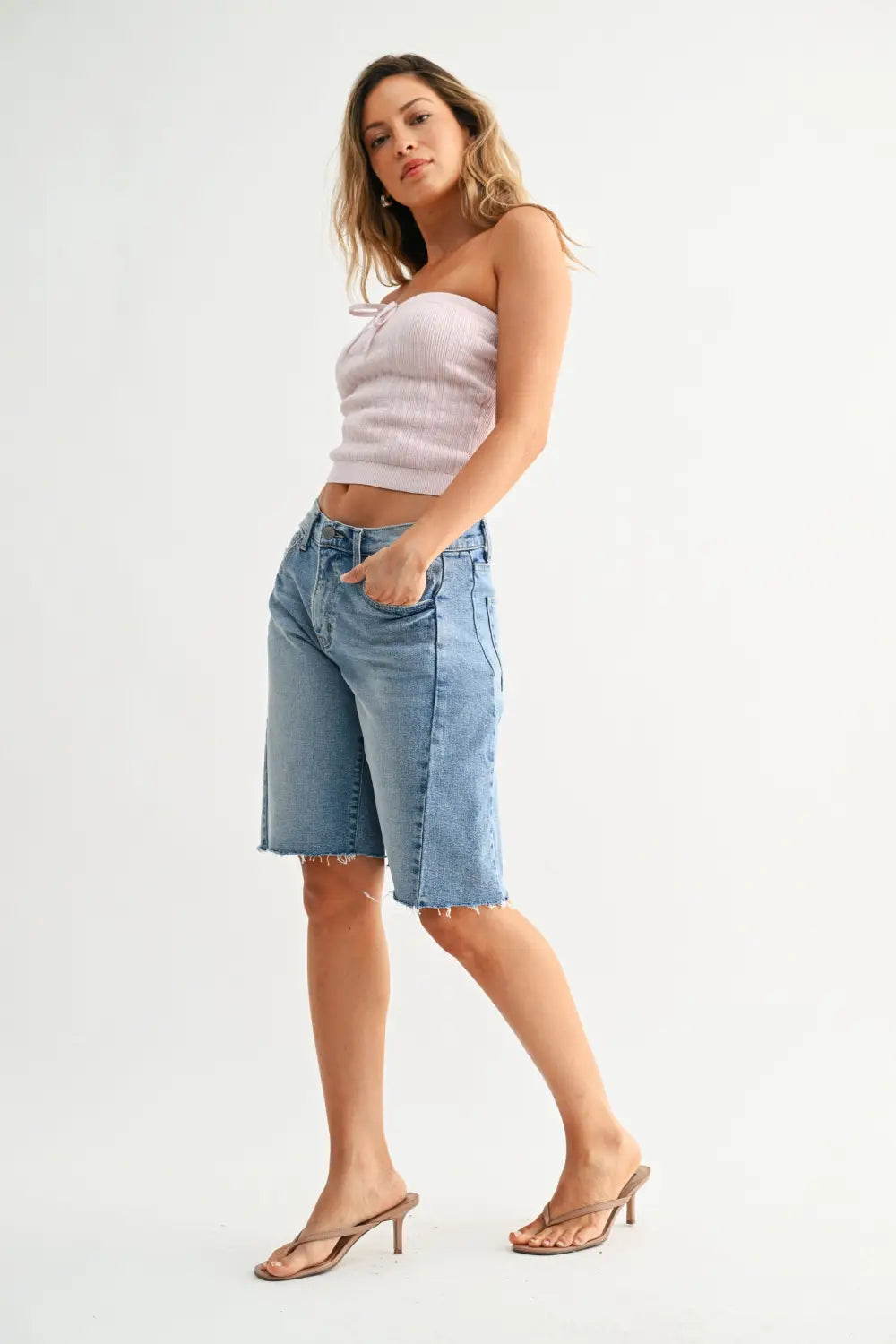 High rise denim shorts in light blue with frayed hem and side seams