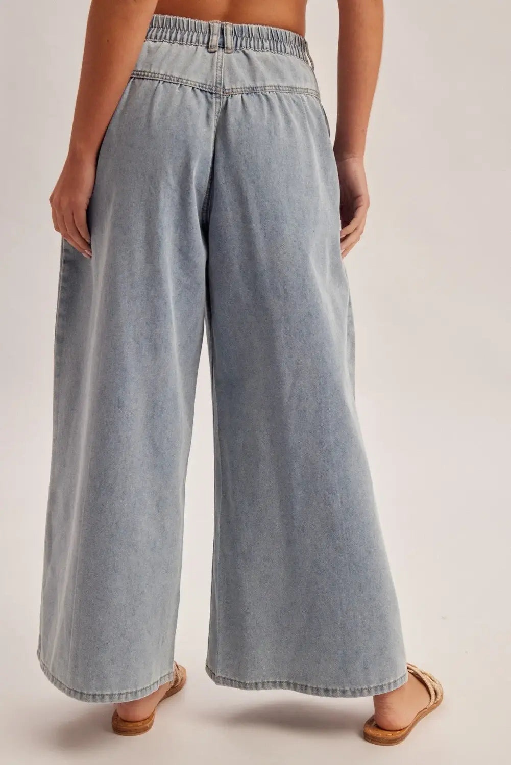 light-wash denim wide leg pants with an elastic waistband featuring a comfortable high rise design perfect for casual wear