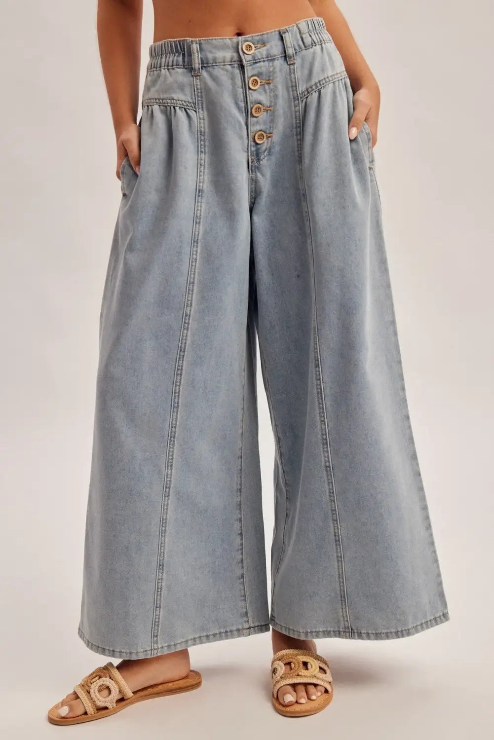 light-wash denim wide leg pants featuring a high rise elastic waist and front button closure in an article titled the wide leg denim youve been looking for seriously