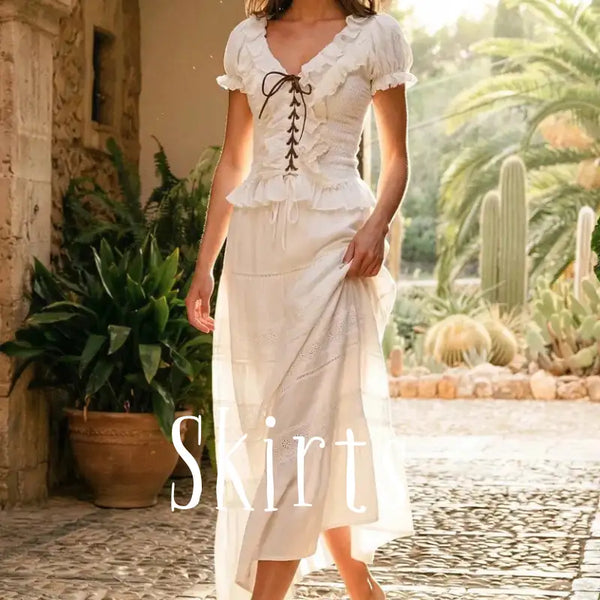 A flowing off-white skirt with delicate ruffles, lace-up corset detailing at the waist, and subtle eyelet embroidery along its length.