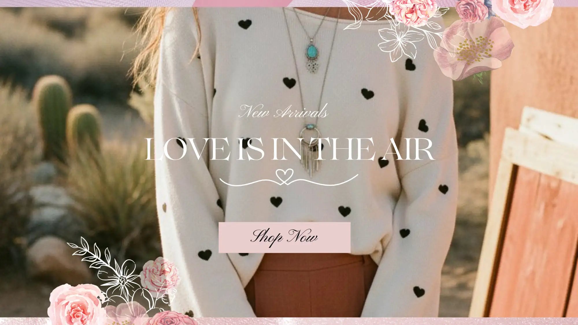 A soft cream-colored sweater adorned with black heart patterns.