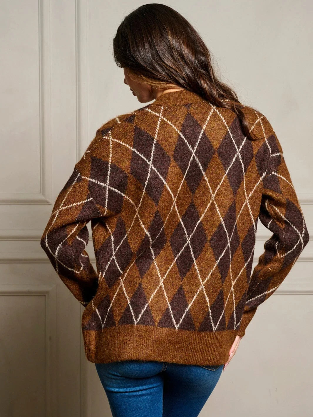 Argyle patterned chocolate brown sweater displayed in a long sleeve open front cardigan