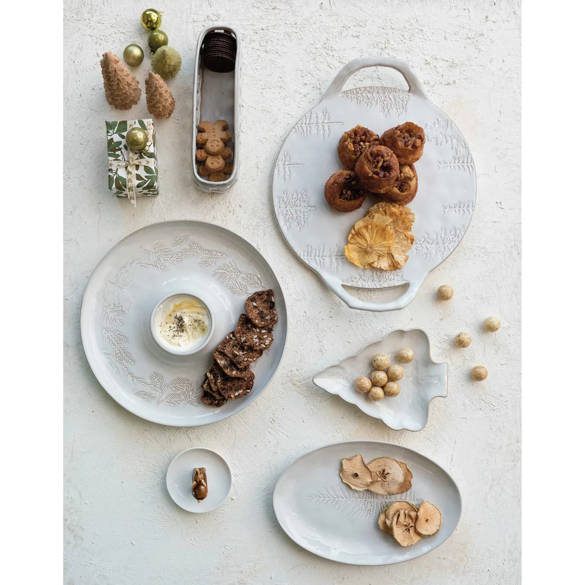 Assortment of snacks on a Debossed Stoneware Platter with Trees in Reactive Glaze