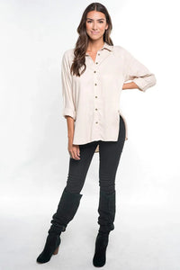 Bohemian long sleeve button down shirt with cuffed sleeves, side slits, paired with black skinny jeans and ankle boots