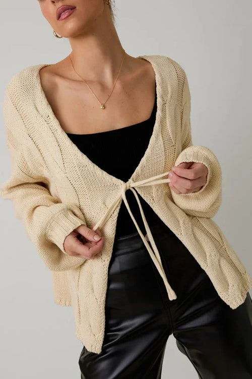 Beige cable knit tie front cardigan with pockets and drawstring closure