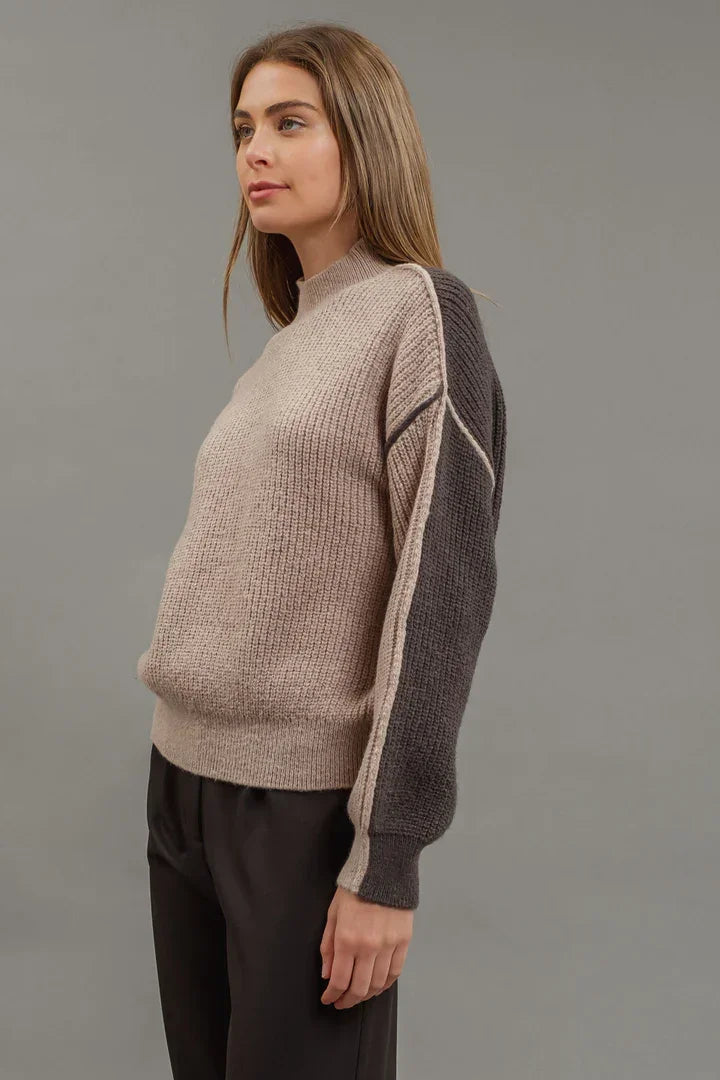 Beige colorblock mock neck knit sweater with gray sleeves and geometric pattern details