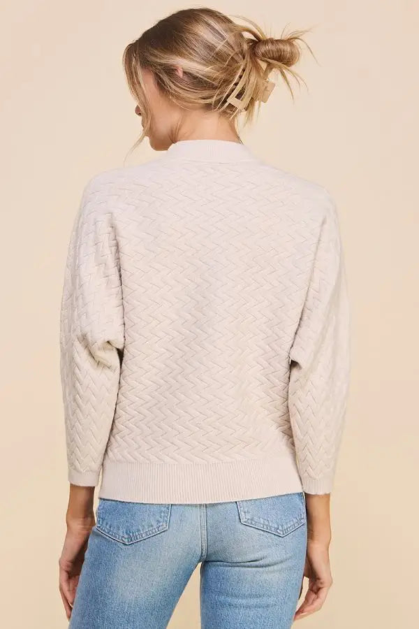 Beige Soft Herringbone Jacquard Mock Neck Dolman Sweater paired with blue jeans