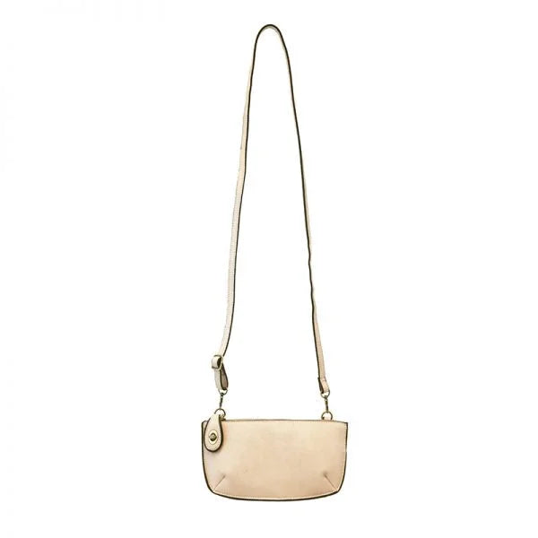 Beige leather crossbody purse with adjustable strap and card slots, ideal for women’s boho chic clothing