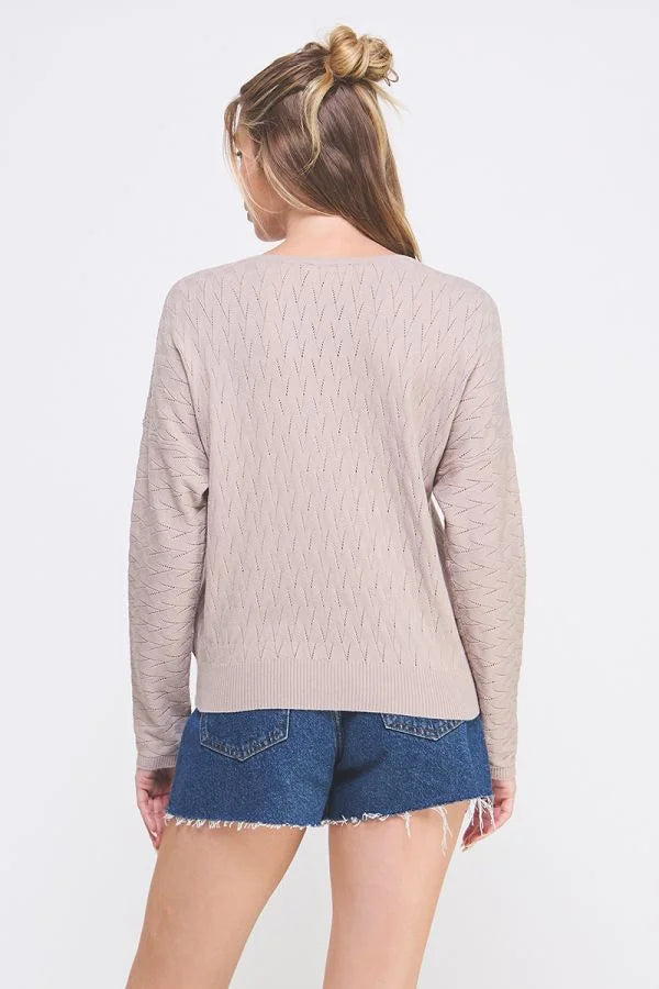 Beige long-sleeved Cable Knit Pattern Pointelle Sweater worn by a person facing away