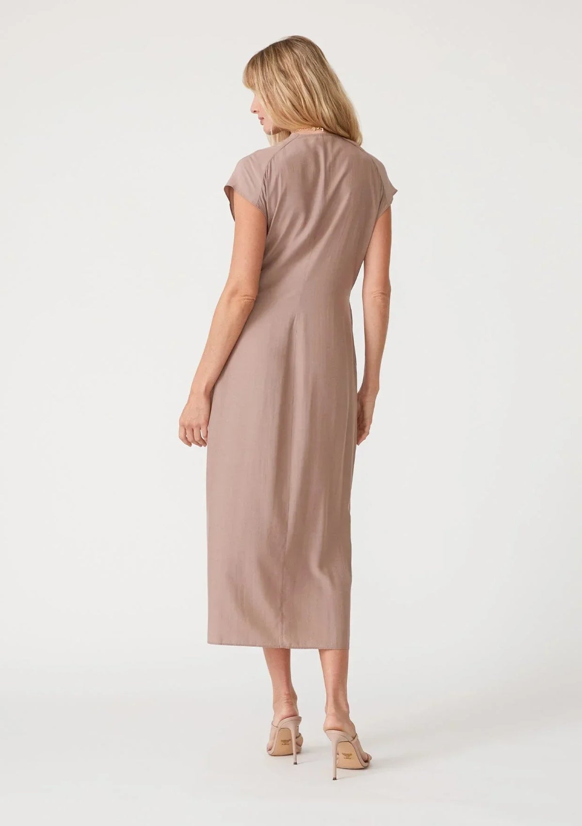 Beige midi wrap dress with short sleeves worn by woman from behind