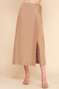 Beige flowy midi skirt with side slit and tie closure for a chic boho look