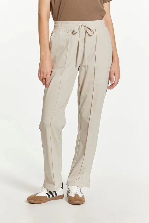 Beige Thread and Supply Paige pants with drawstring, pockets, white sneakers