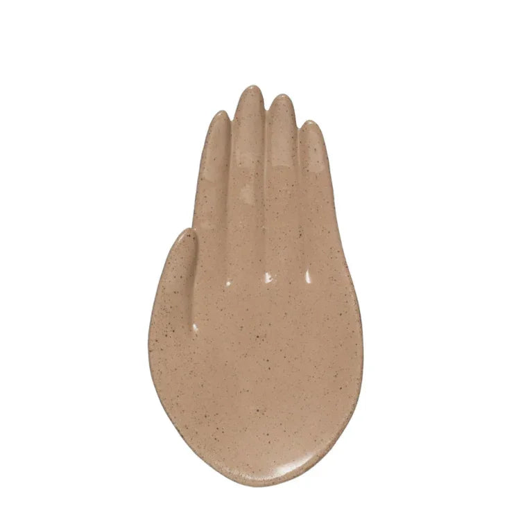 Beige ceramic hand shaped dish designed as a jewelry ring tray with palm facing forward