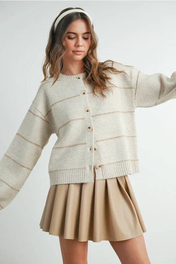 Beige pleated skirt with white buttons in striped cardigan style