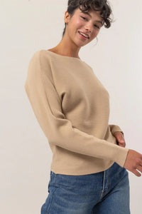 Beige ribbed knit long sleeve sweater with a boat neckline and long sleeves