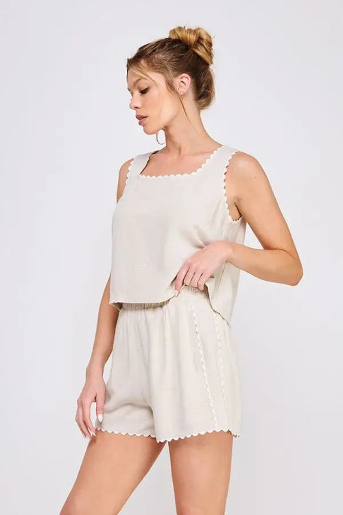 Beige scalloped-edge tank and shorts set with square neck, scalloped trim, and ribbon details