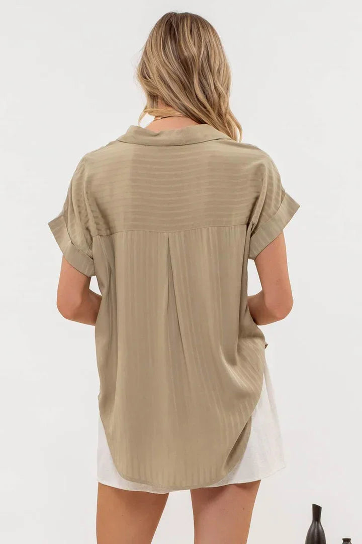 Beige short-sleeved collared split neck blouse shown from behind on a person