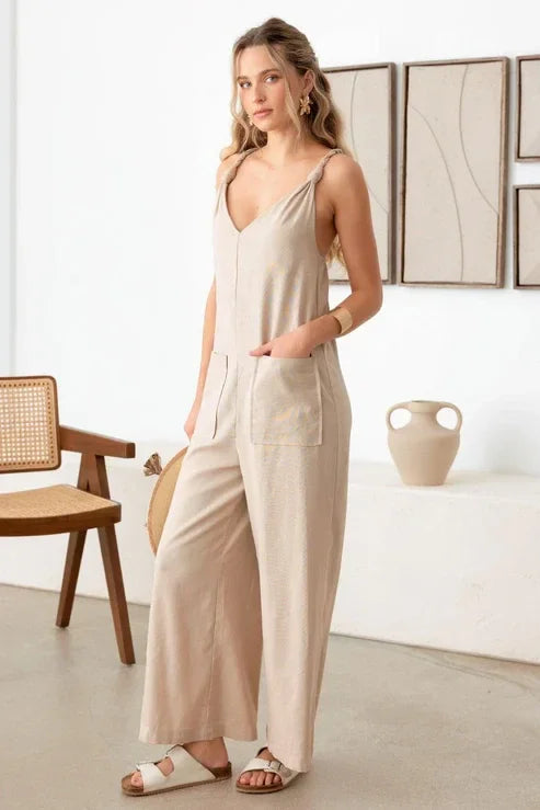 Beige boho sleeveless jumpsuit with rope strap, wide-leg pants, and flowy design