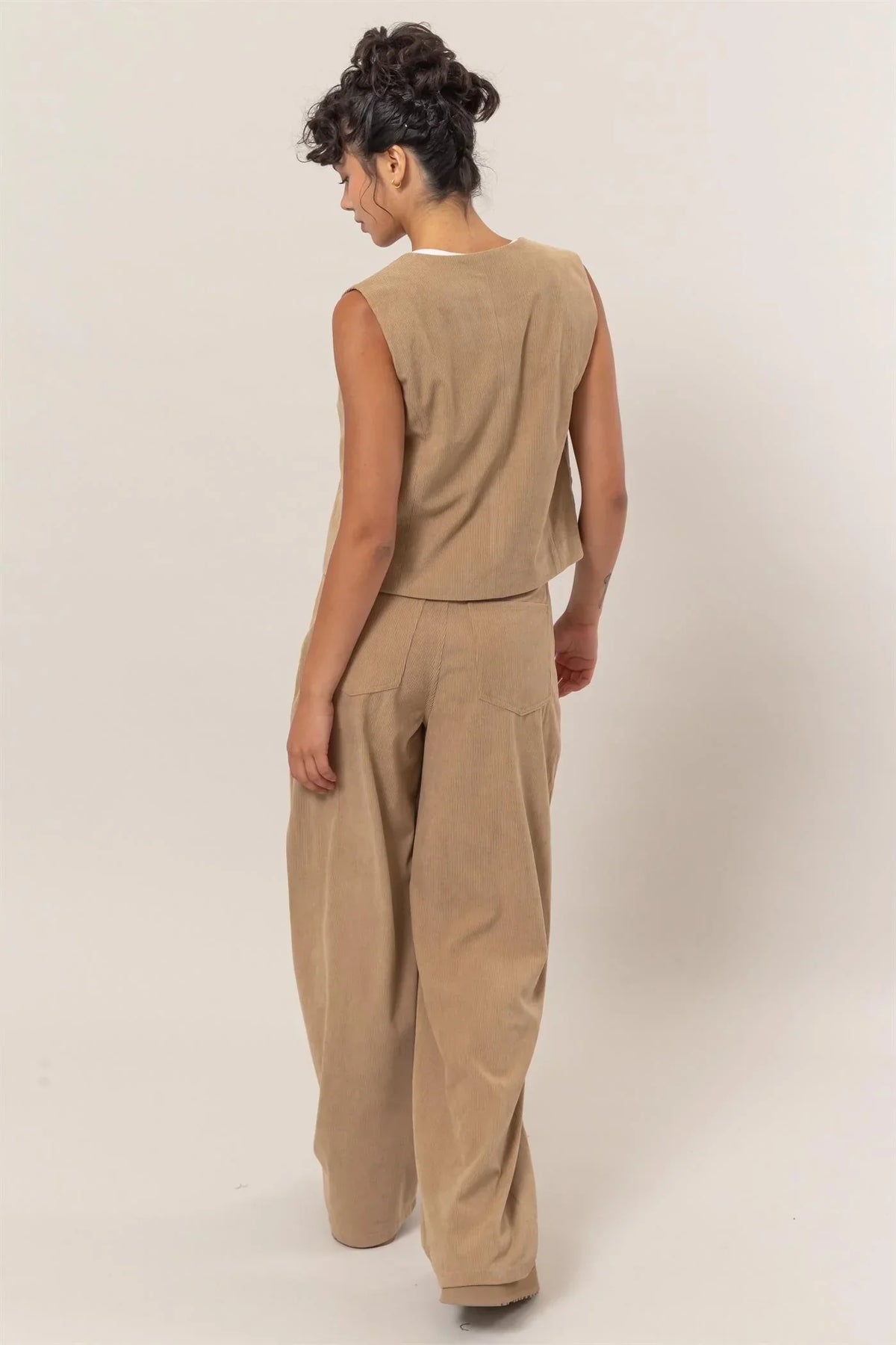 Beige sleeveless jumpsuit with wide-leg pants, featured in Shop Daisy’s women’s boho chic clothing