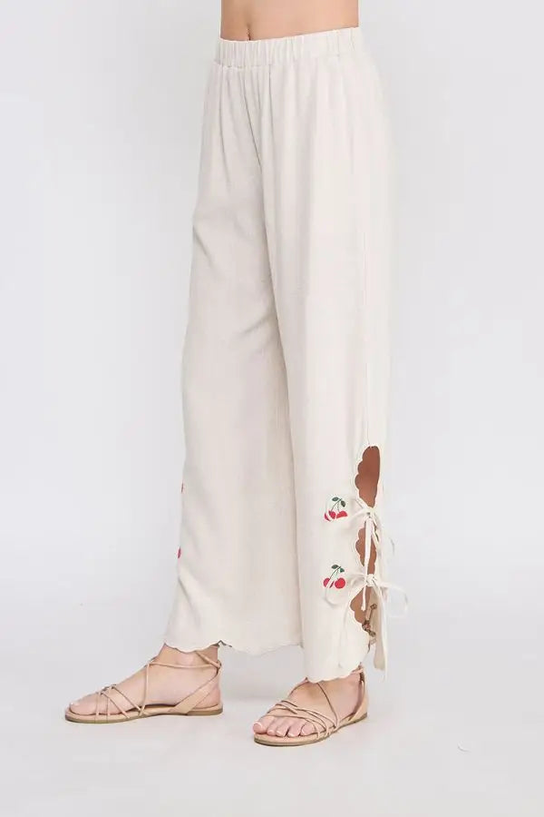 Beige linen elastic waist embroidered pants with cherry-themed cutouts