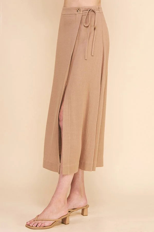 Beige flowy midi skirt with side slit and tie waist, perfect for a boho look