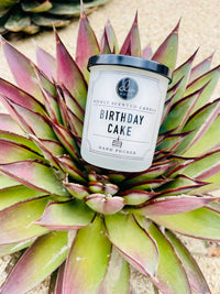 Birthday Cake Mini Candle in a pot on a beach, perfect for seaside celebrations