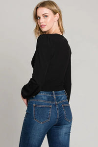 Black cropped sweater with long sleeves, center ruched style, paired with blue jeans, Shop Daisy