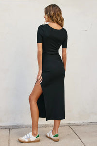 Black fitted short sleeve dress with side slit, ideal for casual or elegant occasions